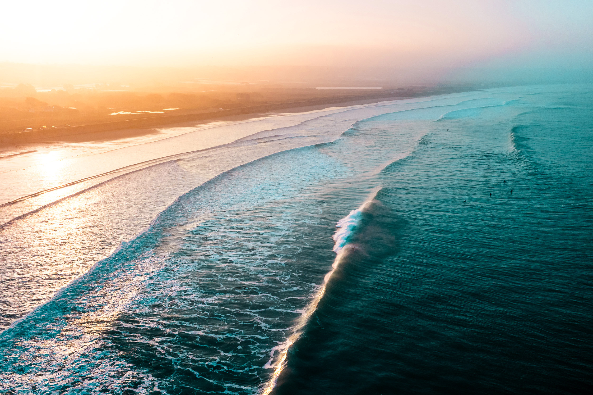 warm yellow sunset with rolling waves on the beach