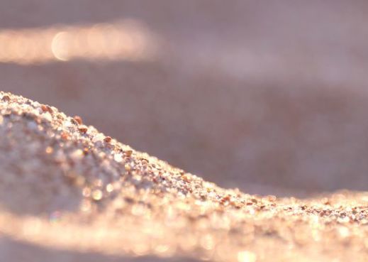 Close up image of golden brown sand.