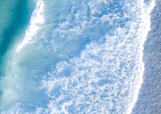 Sea waves crashing on the sand.